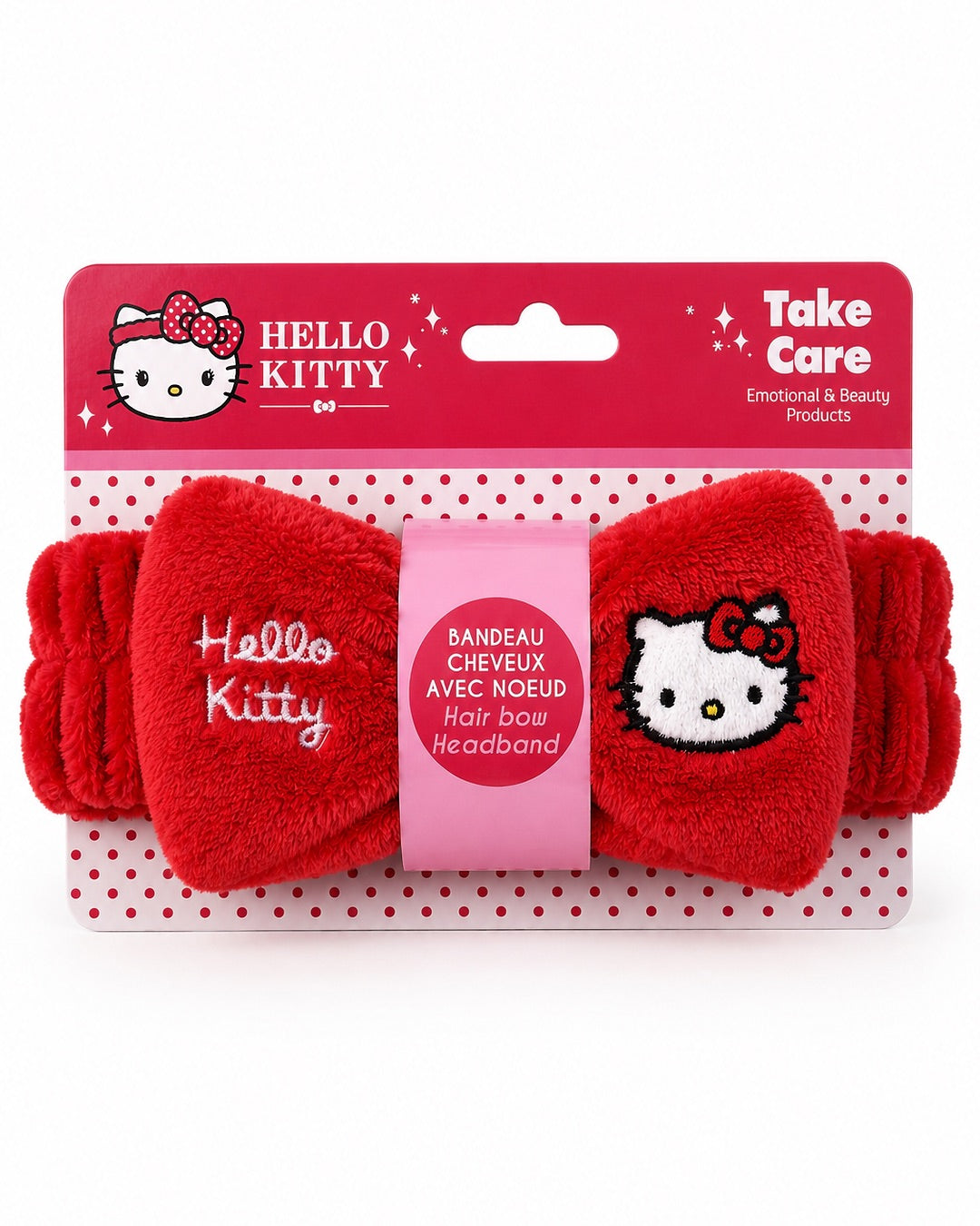 Bandeau de soin Hello Kitty rouge présenté sur sa carte d’emballage d’origine rouge à pois blancs avec le logo officiel Take Care.