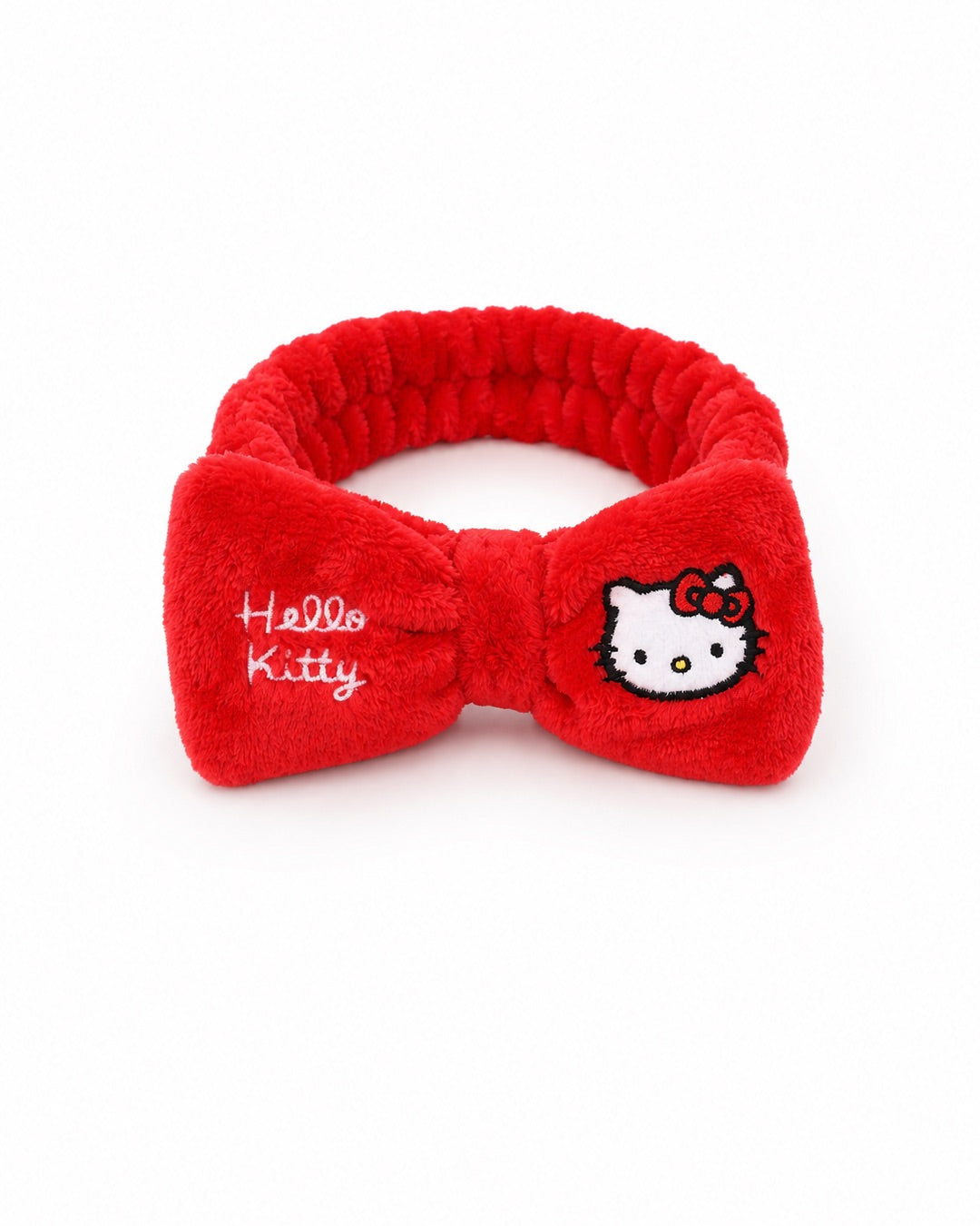 Vue inclinée et surélevée du bandeau élastique de soin Hello Kitty rouge mettant en valeur sa structure extensible et moelleuse.