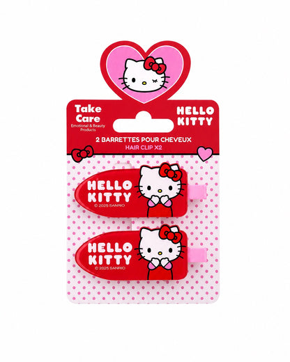 Lot de 2 barrettes pour cheveux Hello Kitty rouges présenté de face sur sa carte d’emballage officielle de la marque Take Care.