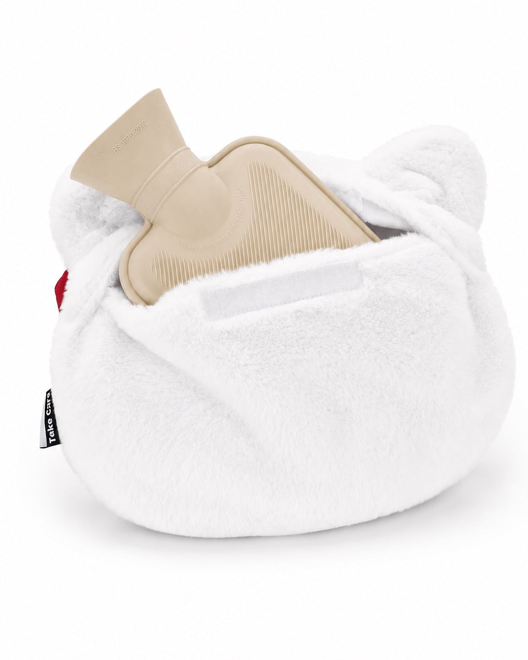 Vue arrière inclinée de la peluche Hello Kitty entièrement ouverte avec la poche de bouillotte en caoutchouc beige déposée à côté.