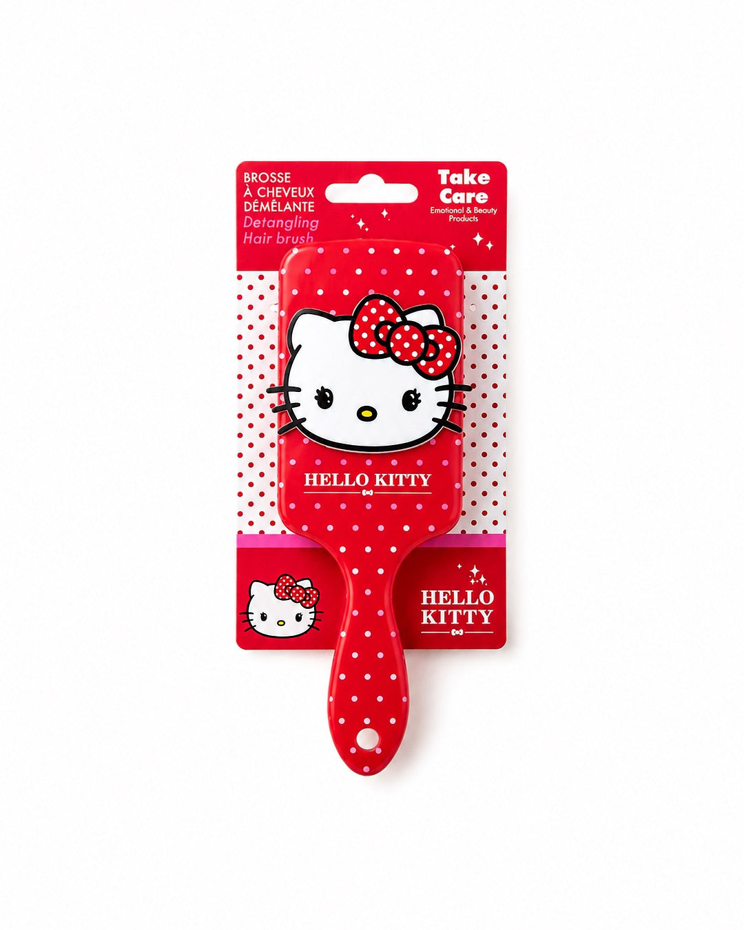 Brosse à cheveux démêlante Hello Kitty présentée sur sa carte d’emballage d’origine rouge et blanche avec mentions officielles Take Care.
