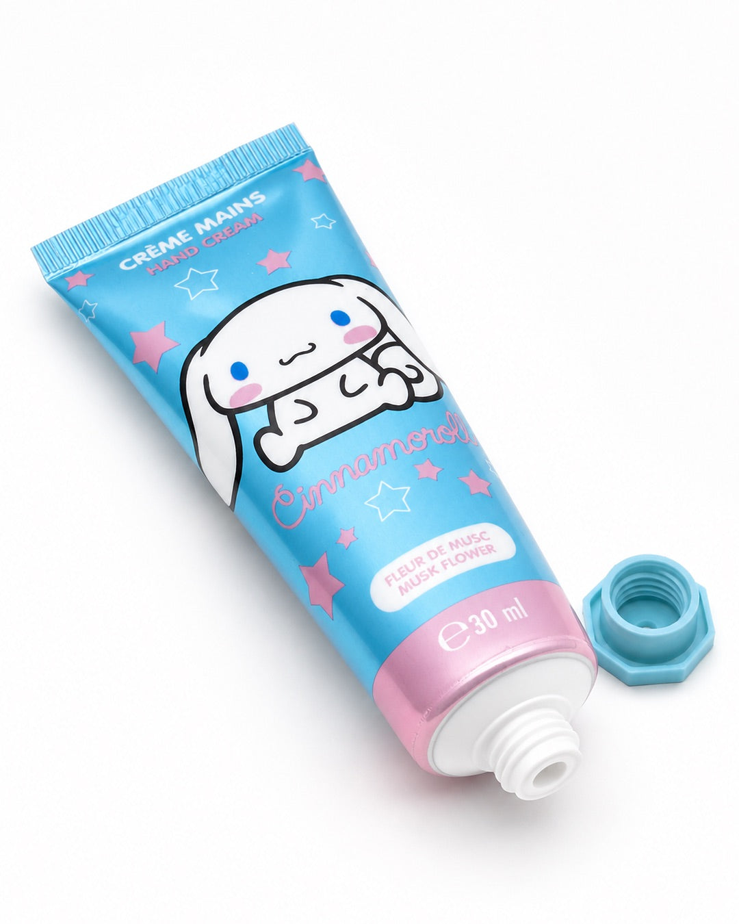 Tube de crème pour les mains de 30 ml bleu métallique et rose avec une illustration du personnage Cinnamoroll de Sanrio et des étoiles.