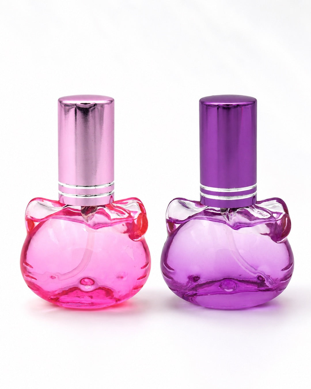Duo de flacons d'eau de toilette rechargeables en verre en forme de tête d’Hello Kitty avec bouchons métallisés, l’un rose bonbon et l’autre violet améthyste, disponibles dans notre boutique en ligne au Québec.