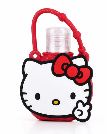 Vue de face d’un flacon à presser de gel nettoyant pour les mains Hello Kitty, inséré dans un étui rond en silicone rouge pailleté à l’effigie de la mascotte.