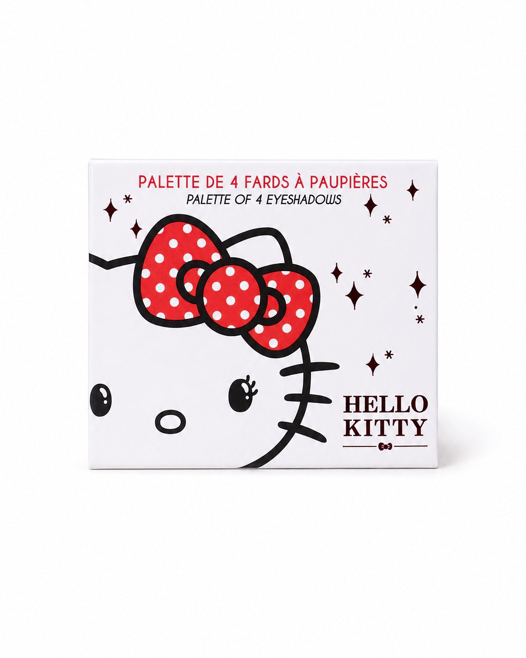 Vue de face du boîtier carré blanc de la palette de 4 fards à paupières Hello Kitty, illustré avec le visage de la mascotte et son nœud rouge à pois blancs.