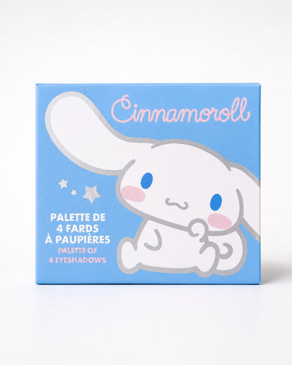 Une palette de fards à paupières Sanrio Cinnamoroll à 4 couleurs ouverte, comprenant des teintes mates et irisées de bleu, gris foncé, brun et argent, avec un applicateur double embout et un miroir intégré.