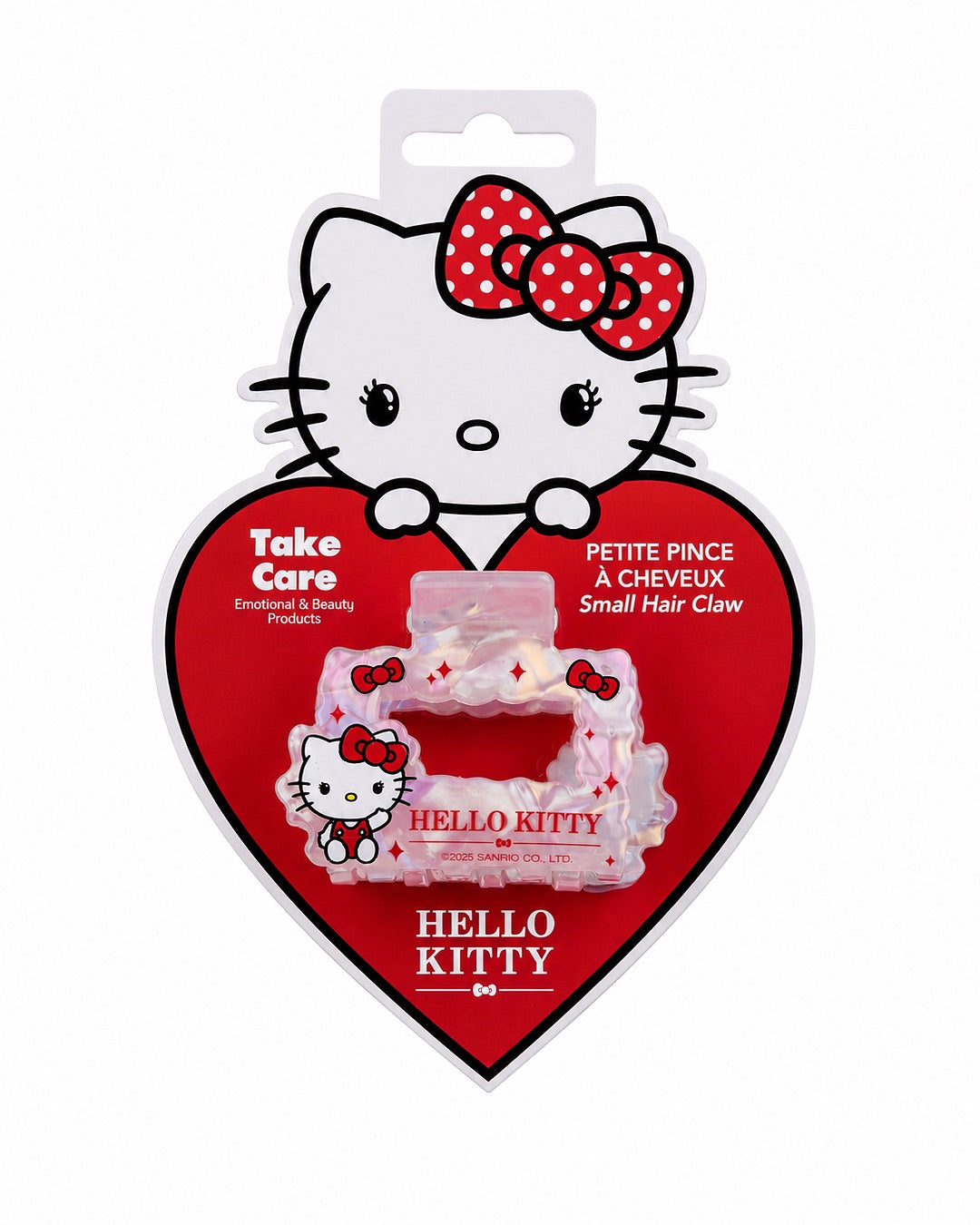 Petite pince à cheveux crabe Hello Kitty présentée de face sur sa carte d’emballage d’origine en forme de cœur rouge.