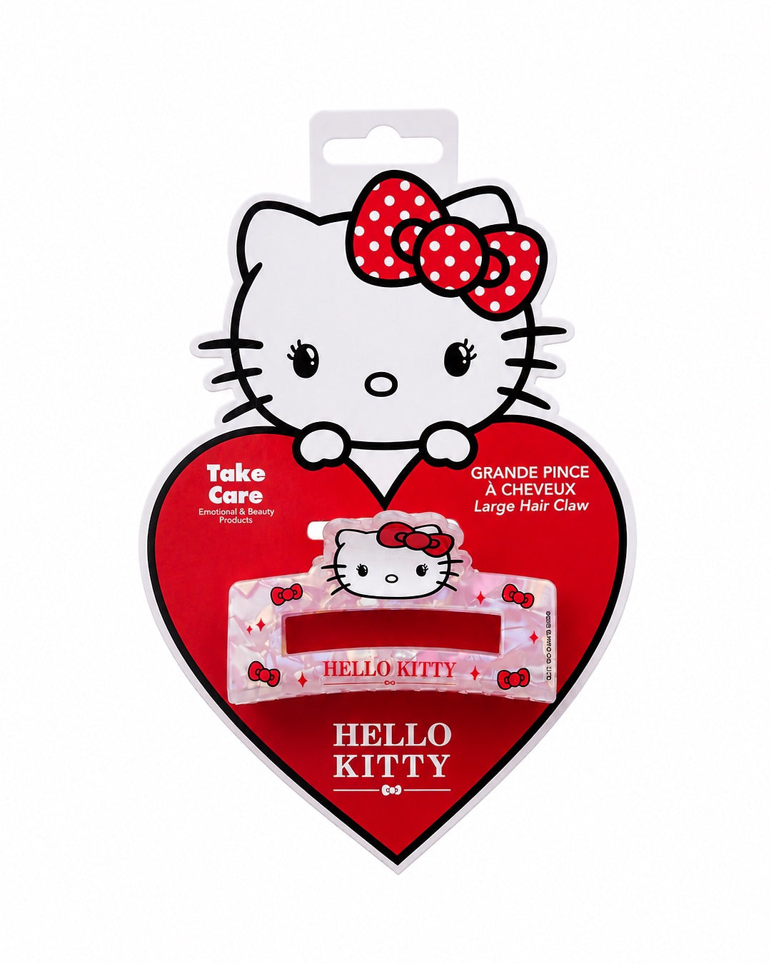 Grande pince à cheveux crabe Hello Kitty présentée de face sur sa carte d’emballage d’origine en forme de cœur rouge.