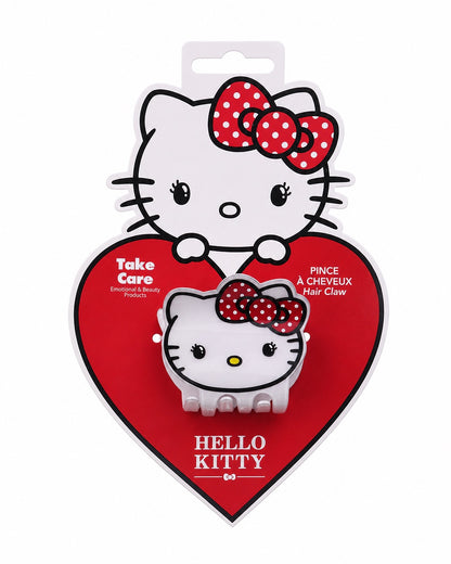 Pince à cheveux blanche Hello Kitty en forme de visage présentée de face sur sa carte d’emballage d’origine en forme de cœur rouge.